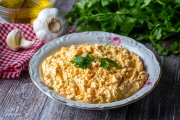 Traditional delicious Turkish foods; Fresh carrot salad with garlic yogurt in bowl. ( Turkish name; havuc tarator) Carrot tarator in ceramic bowl with vegetable on dark background.