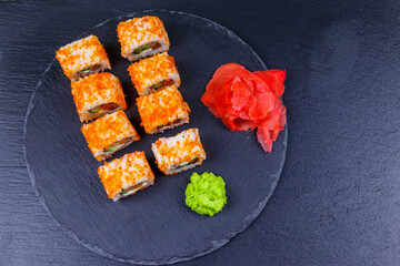 Sushi rolls Philadelphia on a black slate. Top view