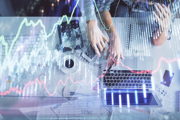 Double exposure of man and woman working together and financial graph hologram drawing. market analysis concept. Computer background. Top View.