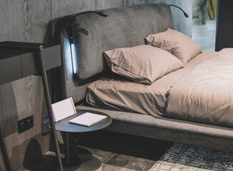 Modern interior, bedroom. Gray sofa, pastel coffee colors with cushions.
Modern Nordic Scandinavian interior design concept. Furniture exhibition.