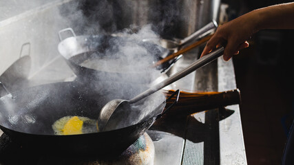 Chef stir fry busy cooking in kitchen