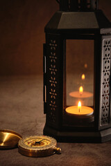 candle lamp and vintage compass on the table