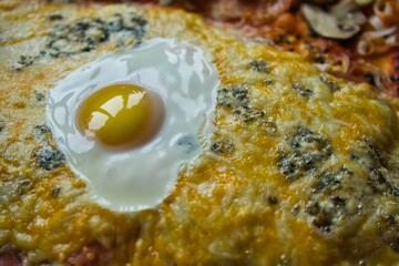 Egg on melted cheese pizza