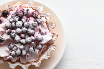 Cooked tart with fresh blueberries and sugar powder. Top view.