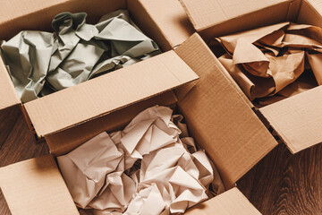 Cardboard boxes with crumpled paper inside for packaging goods from online stores, eco friendly...