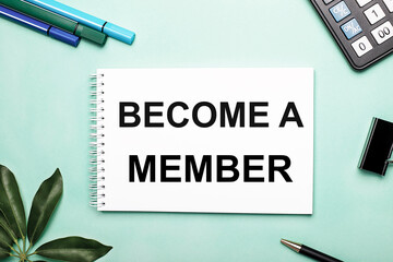 BECOME A MEMBER is written on a white sheet on a blue background near the stationery and the Scheffler sheet. Call to action. Motivational concept