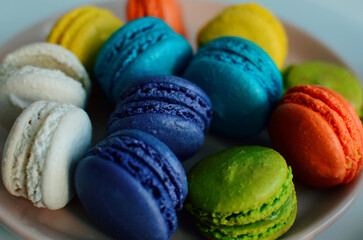 Multicolored macaroons on a plate, close up  