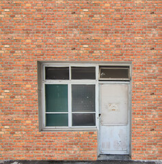 White window at vintage red brick wall