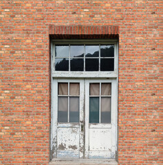 Fototapeta na wymiar White window at vintage red brick wall