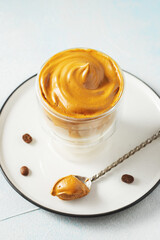 Dalgona coffee. Iced fluffy creamy whipped trend drink with coffee foam and milk. Trendy drink during Covid-19 city lock down and self quarantine, stay at home concept