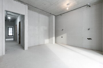 Obraz premium interior of the apartment without decoration in gray colors. rough finish