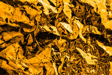 crumpled gold abstract texture background. shining shimmering wallpaper for luxurious and glorious design. modern pattern with shiny sparkle material.