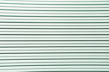 background of white horizontal rows of plastic elements, top view