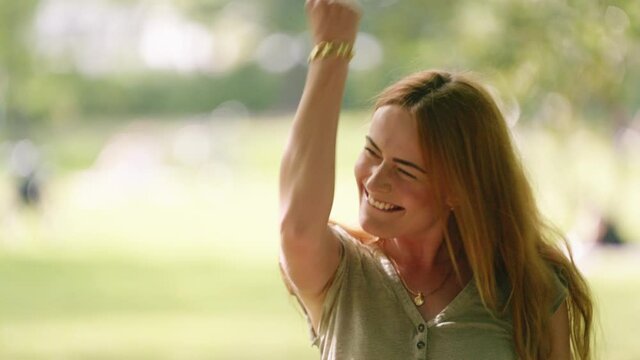[4k] happy dance of beautiful young successful woman cheering