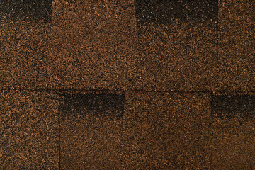 Fototapeta premium brown, grainy background of bituminous roofing tiles, top view