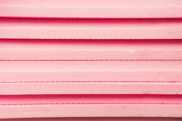 background of stacked, pink expanded polystyrene