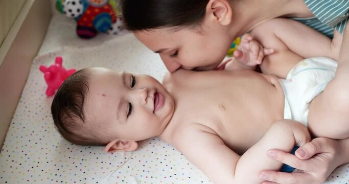 Caring mother and baby are playing in the morning. Concept of baby, parenthood, childhood, maternity, motherhood. slow motion
