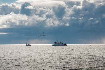 boat sailing in the sea under similar clouds