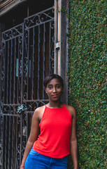 Young African American woman wearing a red blouse. In the city of Cali Valle del Cauca Colombia.