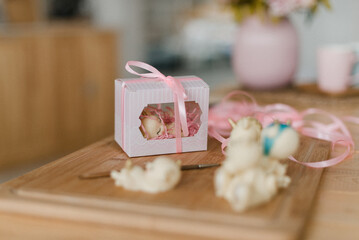 fancy cakes in a box on a wooden table edible toys