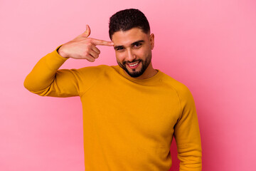 Fototapeta premium Young mixed race man isolated on pink background