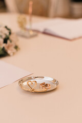 wedding rings on a tray on a white table Wedding