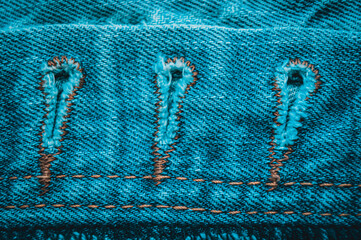 clothing items blue stonewashed faded jeans cotton fabric texture with seams, clasps, buttons and...