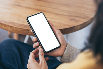 cell phone blank white screen mockup.woman hand holding texting using mobile on desk at office.background empty space for advertise.work people contact marketing business,technology