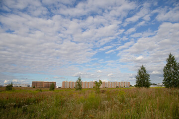 Landscape view to new residential houses against cloudy sky