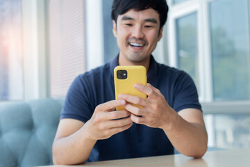 Fototapeta premium asian man work using cell phone hand holding mobile texting message contact us.chatting,search internet information in office.technology device communication connecting