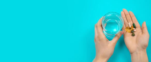 Omega 3 fish oil capsules spilling out of a bottle on a blue background. selective focus.