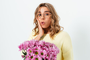 Portrait of surprised young woman with bouquet