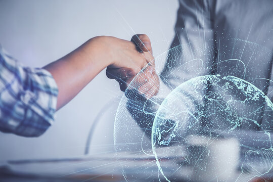 Double exposure of social network theme hologram and handshake of two men.