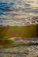 pebble stones on the sea beach, the rolling waves of the sea with foam