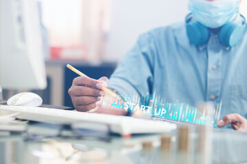 A male businessman looks at the financial trading business by looking at an overview of the...