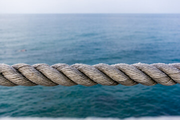 Fototapeta premium old marine rope on the pebble beach