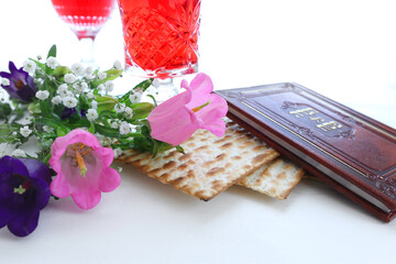 Obraz na płótnie Canvas Pesah celebration concept (jewish Passover holiday). Traditional book with text in hebrew: Passover Haggadah (Passover Tale)