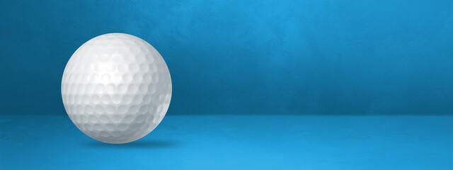 White golf ball on a blue studio banner