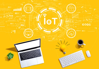 IoT theme with computers with a light bulb from above