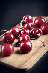 Fresh cherries on a wooden cutting board