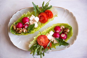 Vegetable salad served in lettuce leaves, light and healthy food or snack