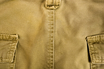clothing items stonewashed cotton fabric texture with seams, clasps, buttons and rivets, macro