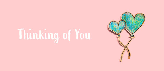 Thinking of you message with hand draw blue hearts - flat lay