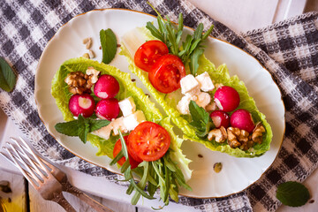 Vegetable salad served in lettuce leaves, light and healthy food or snack