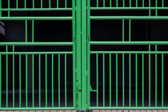 Front View Of Green Metal Gate Of Parking Garage On Dark Background