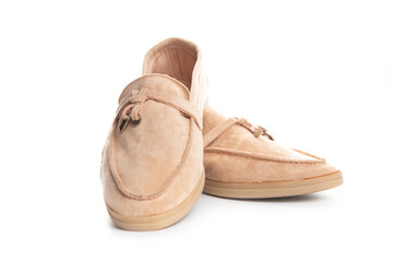 Pair of beige modern unisex loafers on white background