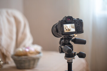 Professional digital camera on a tripod while shooting a home composition.