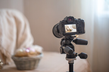 Professional digital camera on a tripod while shooting a home composition.