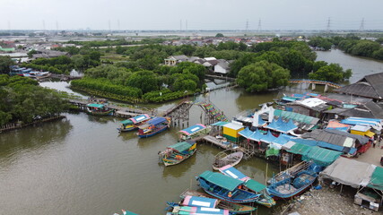 Fototapeta na wymiar Aerial view of fisherman village and mangrove forest in rainy season.