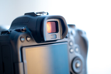 Close up part of a professional digital camera on a blurred background.